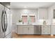 Bright kitchen boasting white cabinets, stainless steel appliances, and hardwood floors at 3361 W 36Th Ave, Denver, CO 80211