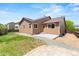 Back exterior with a small concrete patio and landscaping at 6760 E 129Th Ave, Thornton, CO 80602