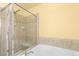 Bathroom with glass enclosed shower and white tub at 6760 E 129Th Ave, Thornton, CO 80602