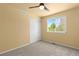 Bright bedroom with neutral carpet, a ceiling fan and closet space, showcasing the room's comfort at 6760 E 129Th Ave, Thornton, CO 80602