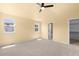 Bright bedroom featuring neutral carpet and two windows with a view at 6760 E 129Th Ave, Thornton, CO 80602