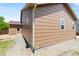 Exterior view of a house with a small gravel path and shed at 6760 E 129Th Ave, Thornton, CO 80602
