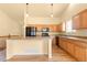 Charming kitchen featuring wood cabinets, a breakfast bar, and hardwood floors at 6760 E 129Th Ave, Thornton, CO 80602