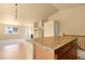 Open-concept kitchen and living area showcasing hardwood floors and natural light at 6760 E 129Th Ave, Thornton, CO 80602