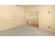 Spacious carpeted room showcasing an open floor plan and ample natural light at 6760 E 129Th Ave, Thornton, CO 80602