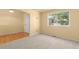 Bright living room with hardwood floors and a large window providing natural light at 6760 E 129Th Ave, Thornton, CO 80602