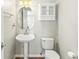 Charming powder room with pedestal sink and storage cabinet at 5140 Mt Pawnee Ave, Frederick, CO 80504