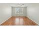 Spacious bedroom with hardwood floors, ceiling fan, neutral paint, and natural light from the large windows at 5140 Mt Pawnee Ave, Frederick, CO 80504