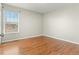 A bright bedroom with hardwood floors, neutral paint, and natural light from the window at 5140 Mt Pawnee Ave, Frederick, CO 80504
