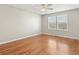 A bright bedroom with hardwood floors, two windows with blinds, and neutral paint, offering a calm atmosphere at 5140 Mt Pawnee Ave, Frederick, CO 80504