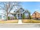 Charming two-story home with a cozy front porch, manicured lawn, and well-maintained landscaping at 5140 Mt Pawnee Ave, Frederick, CO 80504