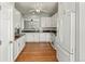 Bright kitchen with white cabinets, granite countertops, stainless steel appliances, and hardwood floors at 5140 Mt Pawnee Ave, Frederick, CO 80504