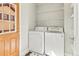 Bright laundry room featuring a washer, dryer, storage shelves, and a stylish tiled floor near an entry door at 5140 Mt Pawnee Ave, Frederick, CO 80504