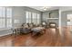 Elegant living room boasts a cozy fireplace, hardwood floors, and plantation shutters for natural light at 5140 Mt Pawnee Ave, Frederick, CO 80504