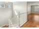 Bright view of the staircase with white banister and hardwood floors leading to other rooms at 5140 Mt Pawnee Ave, Frederick, CO 80504