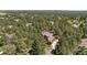 Aerial view of a home surrounded by tall pine trees, showcasing its serene and secluded location at 465 Indian Way, Monument, CO 80132