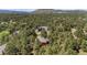 Aerial view of a home surrounded by tall pine trees, with a mountain visible in the distance at 465 Indian Way, Monument, CO 80132