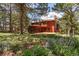 Spacious backyard with a deck, mature trees, and a well-maintained lawn at 465 Indian Way, Monument, CO 80132