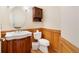 Charming bathroom with wood accents, a pedestal sink, and a classic toilet at 465 Indian Way, Monument, CO 80132