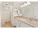 Bathroom featuring a dual sink vanity with large mirror and shower with curtain at 465 Indian Way, Monument, CO 80132