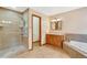 Bathroom features a shower, tub, vanity, and tile floors at 465 Indian Way, Monument, CO 80132