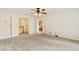 Bedroom with neutral carpet, ceiling fan, and access to an attached bathroom and hallway at 465 Indian Way, Monument, CO 80132