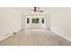 Spacious bedroom with neutral carpet, ceiling fan, and bay window overlooking the yard at 465 Indian Way, Monument, CO 80132