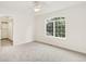 Bright bedroom with plush gray carpeting, large window, and walk-in closet at 465 Indian Way, Monument, CO 80132