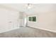 Bright bedroom featuring plush gray carpeting, closet, and built-in shelving at 465 Indian Way, Monument, CO 80132