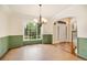 Dining room featuring wainscoting, hardwood floors, and a large window with views at 465 Indian Way, Monument, CO 80132