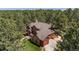 Two-story home featuring an attached two-car garage and outdoor patio, nestled among mature pine trees at 465 Indian Way, Monument, CO 80132