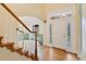 Welcoming foyer with hardwood floors, staircase, and decorative front door at 465 Indian Way, Monument, CO 80132