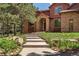 Inviting front exterior featuring brick accents, manicured landscaping, and stone steps at 465 Indian Way, Monument, CO 80132