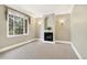 Cozy living room with carpet, fireplace, and large window overlooking greenery at 465 Indian Way, Monument, CO 80132