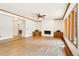 Bright living room showcasing hardwood floors, white brick fireplace, and large windows offering ample natural light at 465 Indian Way, Monument, CO 80132