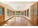 Sunlit living space with a wall of windows, wood floors, built-in cabinets, and scenic views at 465 Indian Way, Monument, CO 80132