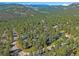 Picturesque mountain community aerial view showcasing winding roads amid a canopy of evergreen trees at 4228 Scenic Village Dr, Evergreen, CO 80439