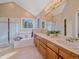 Bright bathroom with double sinks, a soaking tub, and a glass enclosed shower at 4228 Scenic Village Dr, Evergreen, CO 80439