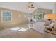 This sunlit bedroom features vaulted ceilings, large windows, and cozy neutral carpeting at 4228 Scenic Village Dr, Evergreen, CO 80439