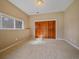 Cozy bedroom with soft lighting, carpet flooring, and a large closet with natural wood doors at 4228 Scenic Village Dr, Evergreen, CO 80439