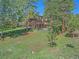 Rear exterior view of home with wooded surroundings at 4228 Scenic Village Dr, Evergreen, CO 80439