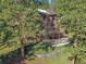 Exterior of a well-maintained home surrounded by lush green trees at 4228 Scenic Village Dr, Evergreen, CO 80439