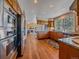 Spacious kitchen with stainless steel appliances, granite counters, and a breakfast bar, flowing into the living area at 4228 Scenic Village Dr, Evergreen, CO 80439