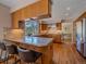 Kitchen featuring granite countertops, stainless steel appliances, bar seating, and hardwood floors at 4228 Scenic Village Dr, Evergreen, CO 80439