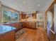 Well-appointed kitchen featuring granite countertops, wood cabinets, and stainless steel appliances with hardwood floors at 4228 Scenic Village Dr, Evergreen, CO 80439