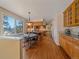 Open kitchen with eat-in dining area features hardwood floors, and a view of the living area at 4228 Scenic Village Dr, Evergreen, CO 80439