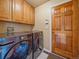 Laundry room with wooden cabinets, modern washer and dryer, and convenient access door at 4228 Scenic Village Dr, Evergreen, CO 80439