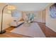 Inviting living room featuring hardwood floors, crown molding, and large windows offering ample natural light at 4228 Scenic Village Dr, Evergreen, CO 80439