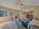 Spacious living room open to kitchen has multiple windows offering scenic backyard views at 4228 Scenic Village Dr, Evergreen, CO 80439