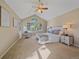 Spacious main bedroom boasts vaulted ceilings, sitting area, natural light, and plush carpeting at 4228 Scenic Village Dr, Evergreen, CO 80439